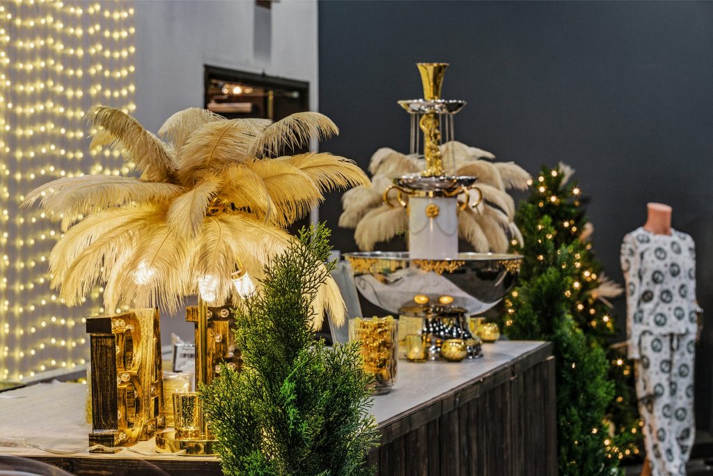 Elegant banquet bar setup with gold feather lamps, decorative lights, and luxury event styling