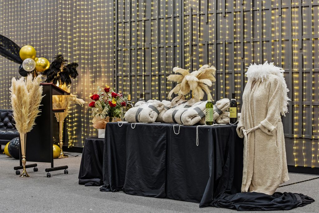 Luxury event setup with decorated table, robe display, fairy lights, and elegant accessories