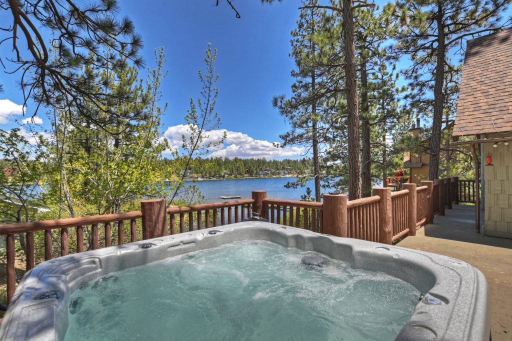 An outdoor hot tub on a deck with a lake view in Big Bear.
