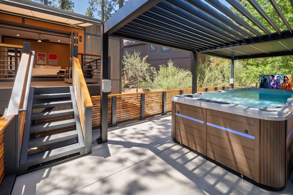 Modern outdoor spa deck at Castlewood Pines with covered jacuzzi area and mountain retreat atmosphere.
