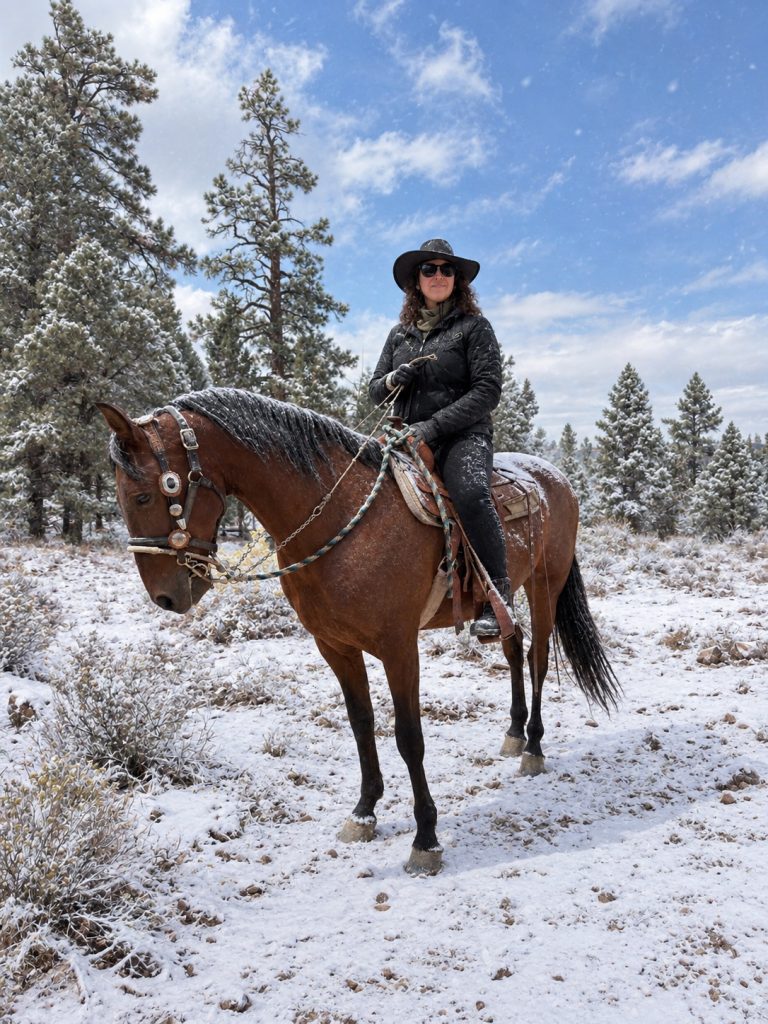 Rider enjoying a snowy horseback trail adventure surrounded by pine trees in Big Bear