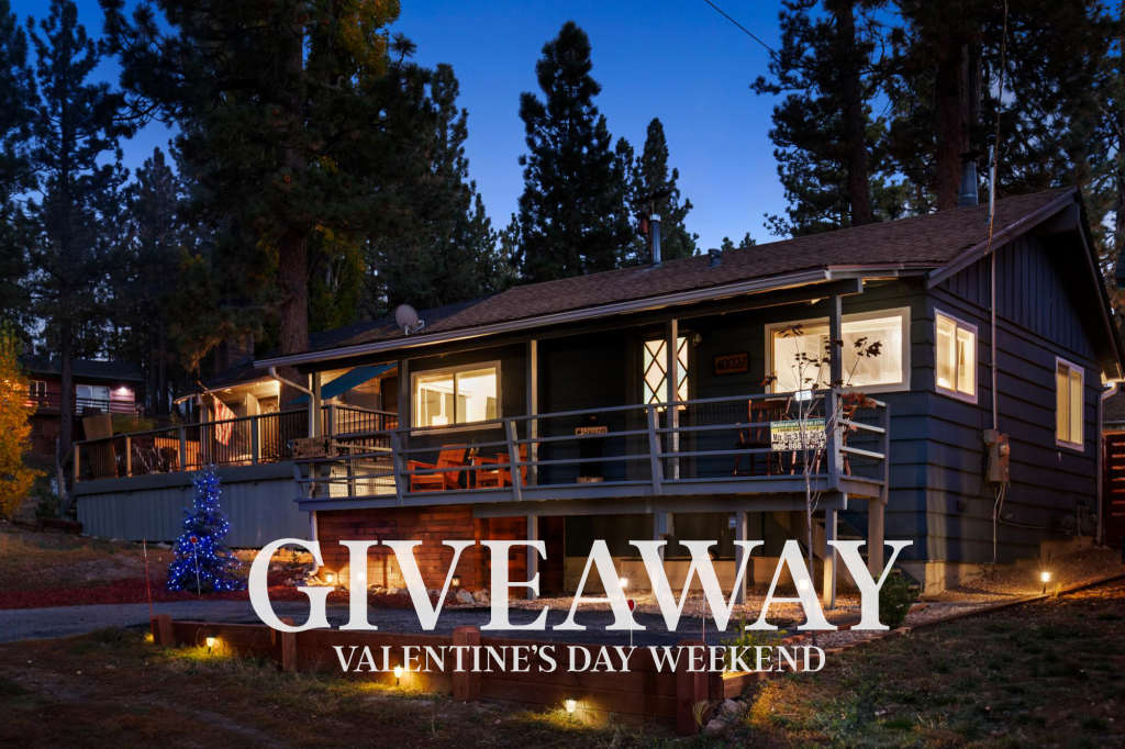 A cozy cabin is shown at dusk, with lights illuminating the exterior and a small tree decorated with blue lights in the yard. The words "GIVEAWAY" and "VALENTINE'S DAY WEEKEND" are overlaid on the image.