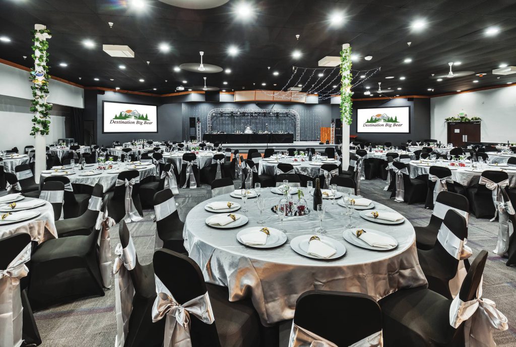 Banquet room with Destination Big Bear branding and stage setup