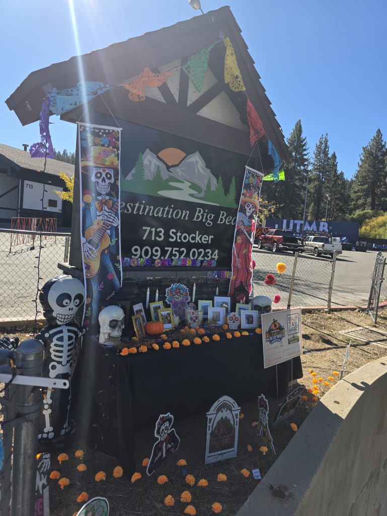 Destination Big Bear sign decorated with Halloween items pumpkins skulls at the monument sign