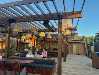De la Nonna Restaurant Big Bear Lake - Outdoor Patio looking at people seated under outdoor pergola
