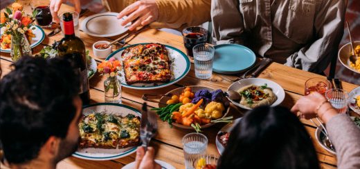 A group of people enjoying a meal together at a table in DeLaNonna Restaurant, Big Bear.