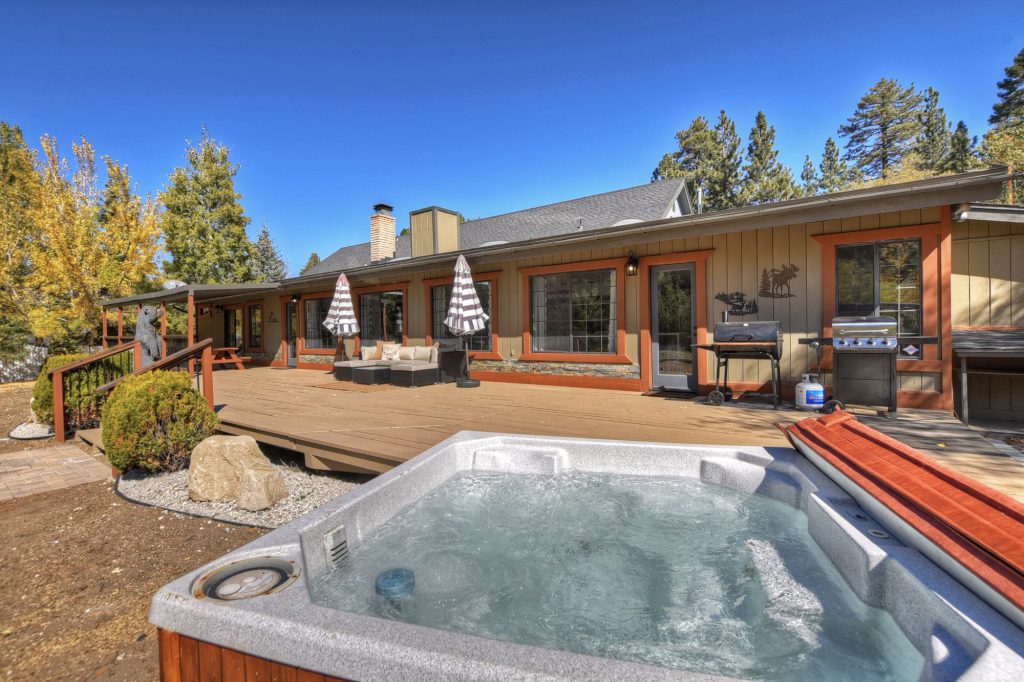 An outdoor hot tub on a large deck at a cabin in Big Bear.