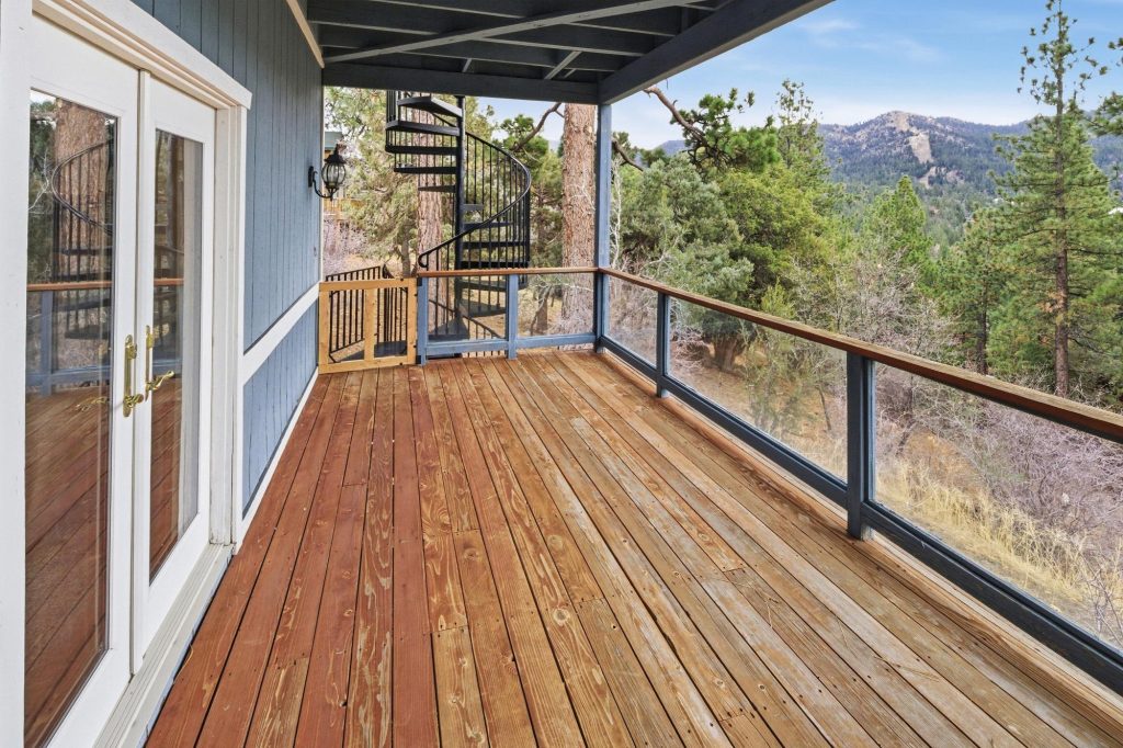 Spacious balcony deck at Edgar’s Hideaway overlooking forest and mountain scenery in Big Bear.