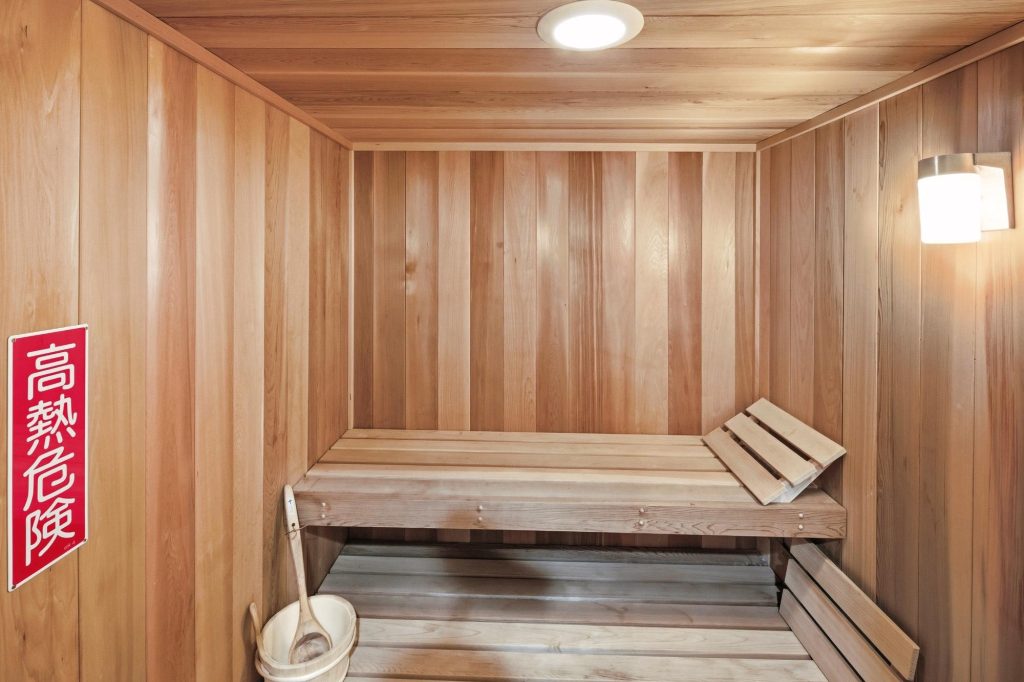 Cedar wood sauna interior at Edgar’s Hideaway featuring bench seating and warm lighting.