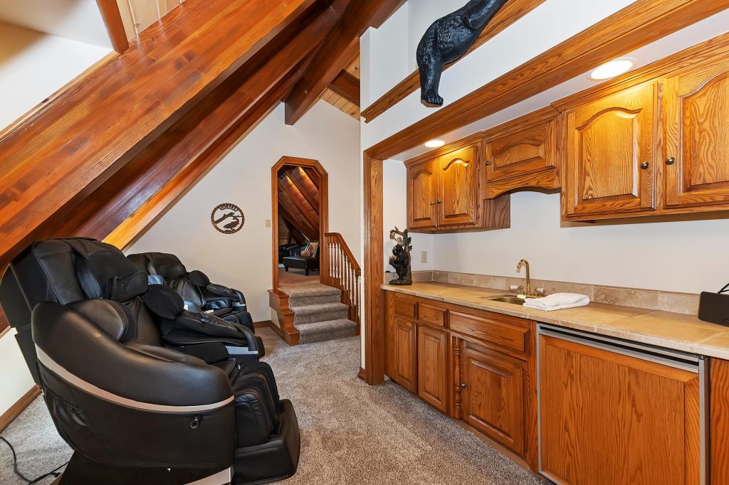 Relaxation lounge at Edgewood Mansion featuring massage chairs, wood interiors, and built-in cabinetry.