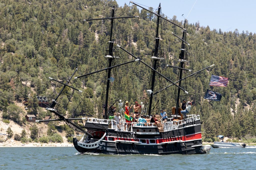 Pirate ship tour on Big Bear Lake with people enjoying a themed boat ride