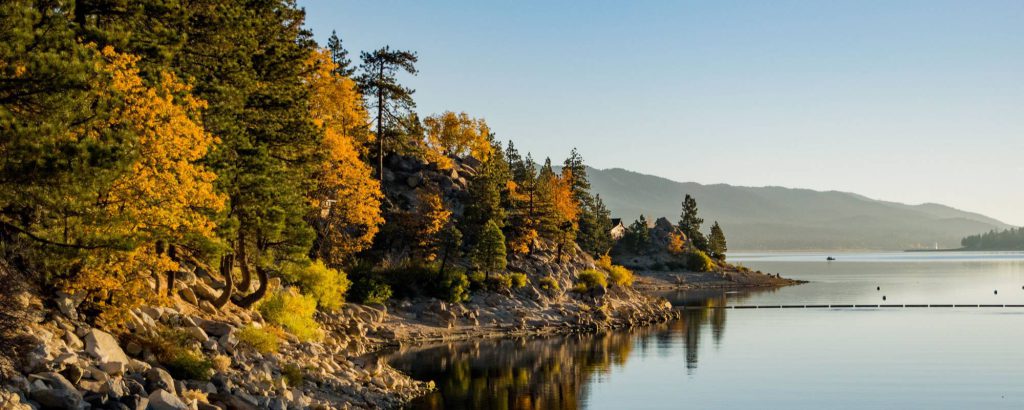 Scenic fall view of Big Bear Lake with golden trees and calm water