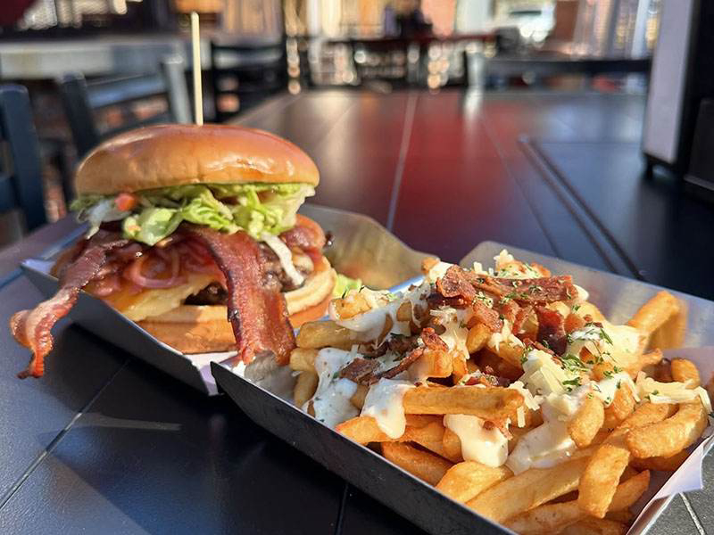 Fire Rock burger with crispy fries served on a tray at the restaurant