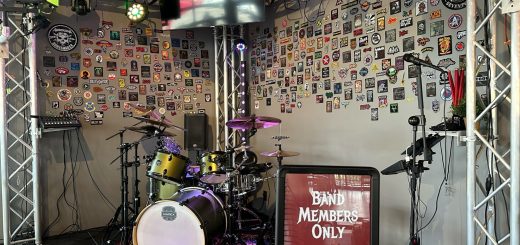 Live music stage setup at Fire Rock Burgers & Brews featuring drums, lighting, and performance equipment