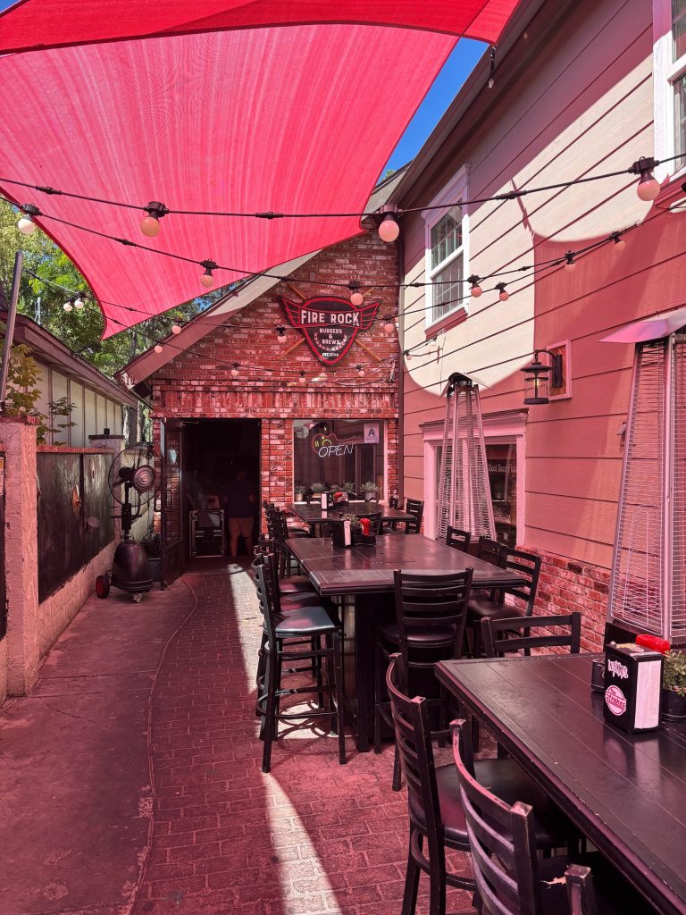Fire Rock Burgers & Brews outdoor patio with shaded seating area and restaurant entrance