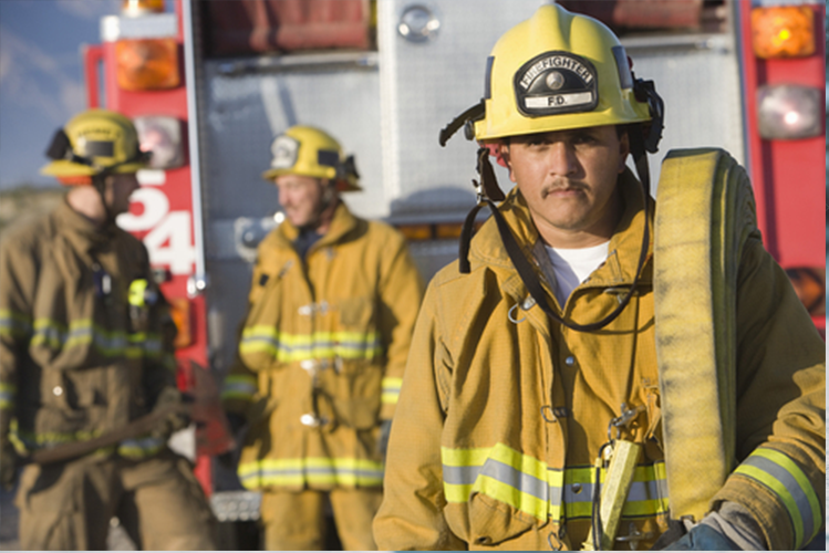 Fire fighter with hose looking at camera