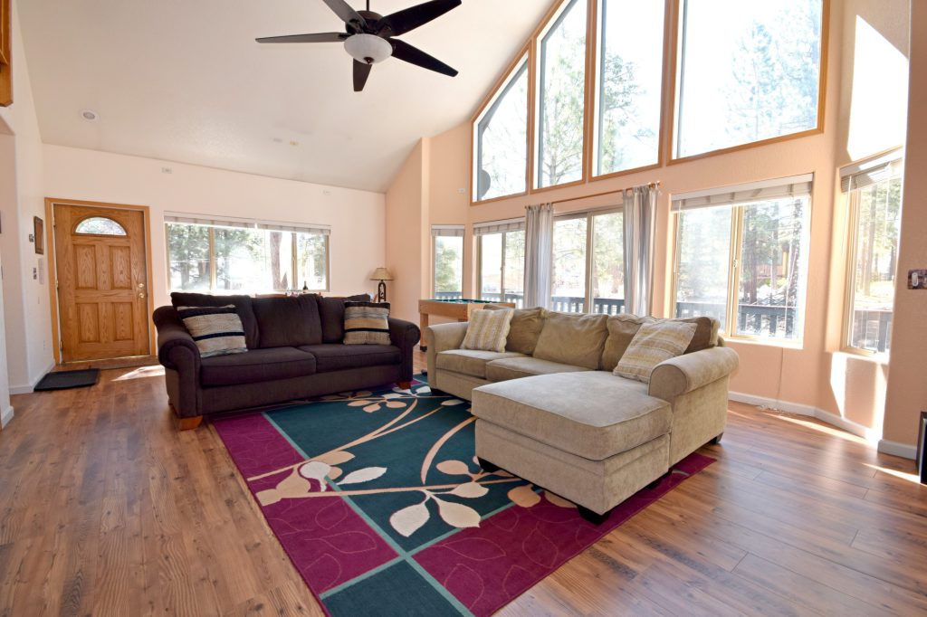 Forest Hollow Big Bear living room before renovation with couches and large windows