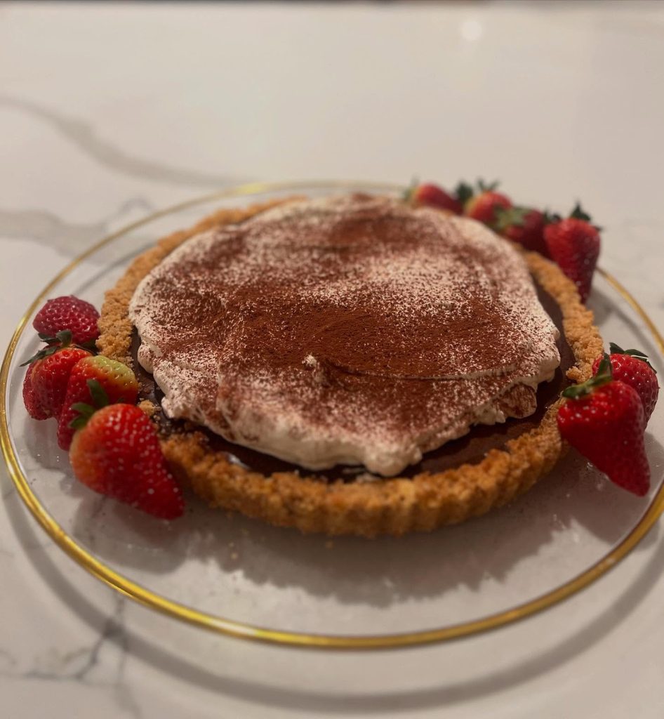 Chocolate-topped cream pie with a golden crust and fresh strawberries at Forkful Big Bear