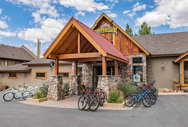 Front exterior of Goldsmiths Sports in Big Bear featuring mountain bikes, cruiser bikes, and a rustic lodge-style storefront.