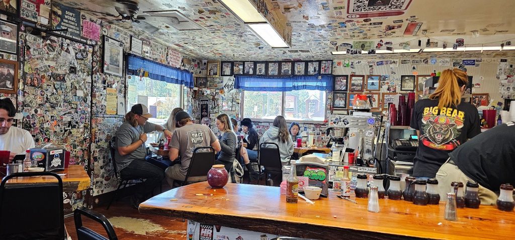 Interior of Grizzly Manor Cafe with customers enjoying breakfast at tables.