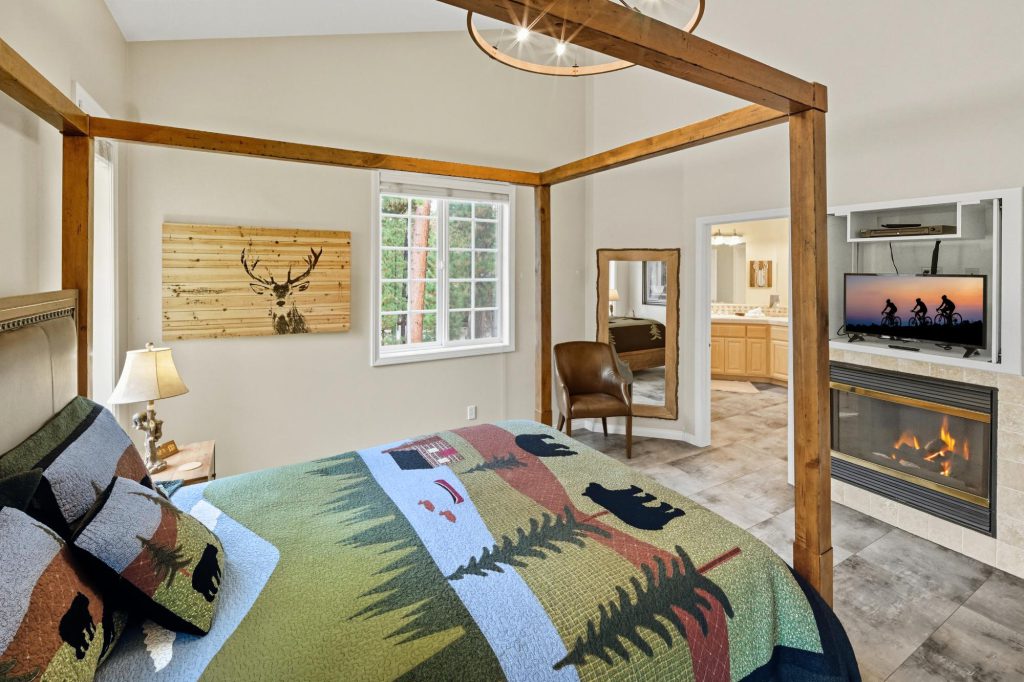 The Hidden Estate Big Bear luxury rental by Destination Big Bear bedroom with mountain inspired bedspread on a post bed in a bedroom
