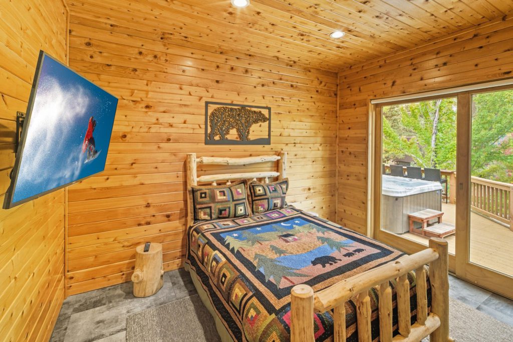 The Hidden Estate in Big Bear luxury rental by Destination Big Bear. Bedroom with log post single bed and log walls.