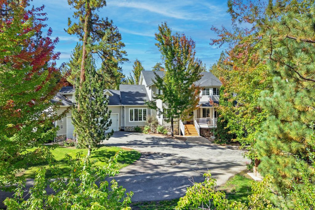 The Hidden Estate cabin rental in Big Bear California exterior hidden in the pine trees on a beautiful fall day.