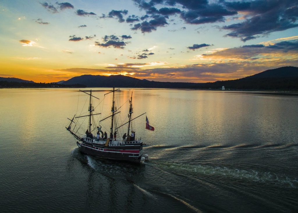 Pirate ship cruise sailing across Big Bear Lake during sunset at Holloway’s Marina