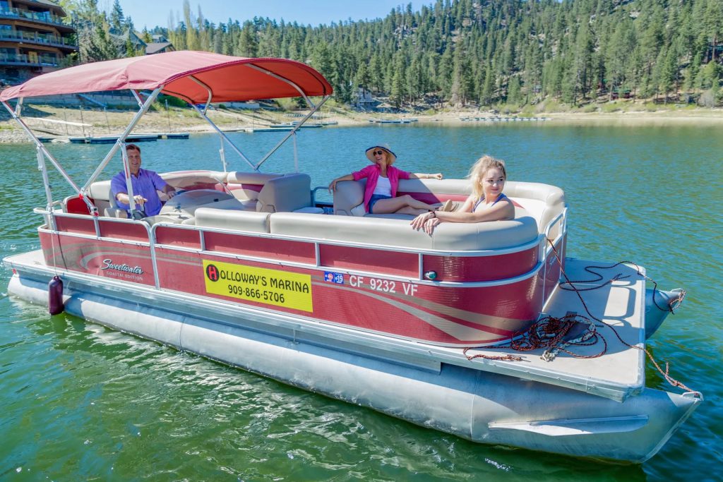 Pontoon boat rental on Big Bear Lake at Holloway’s Marina with guests enjoying a relaxing ride on the water