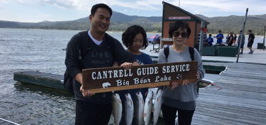 Family showing their trout catch with Cantrell Guide Service at Big Bear Lake marina