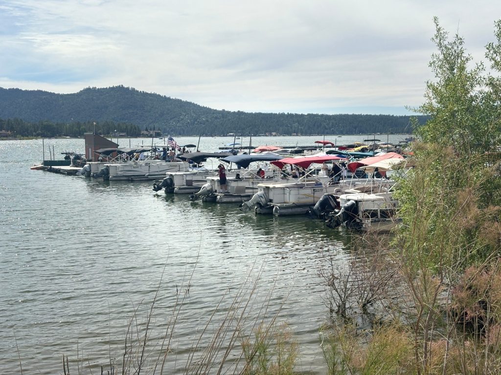 Boats docked at Big Bear Lake marina with mountains in the background