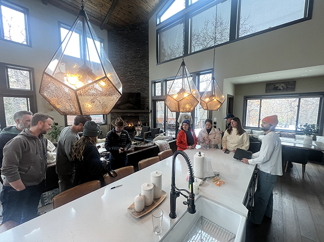 A group of people standing in a kitchen during the Kim Lansell production shoot in Big Bear.