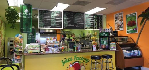 Dining area inside Juice Factory Big Bear with menu boards, seating, and fresh smoothie preparation station.