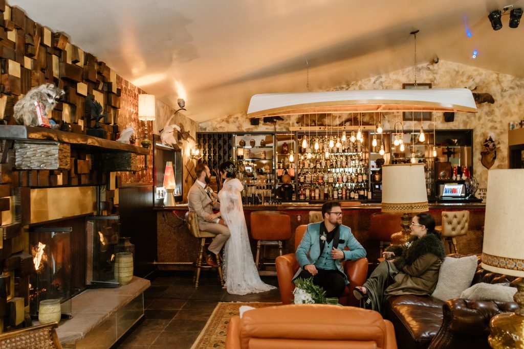 Guests enjoying the cozy bar and fireplace area at Sessions Retreat Big Bear.