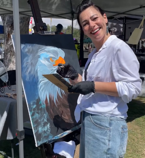 Artist painting a bald eagle artwork during the Lakefest Paint and Sip event outdoors