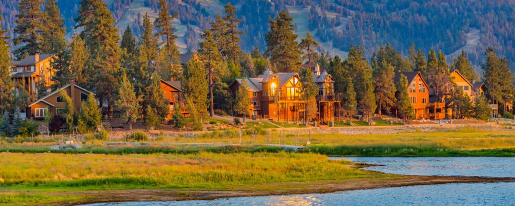 Scenic view of Big Bear lakefront cabins with mountains in background