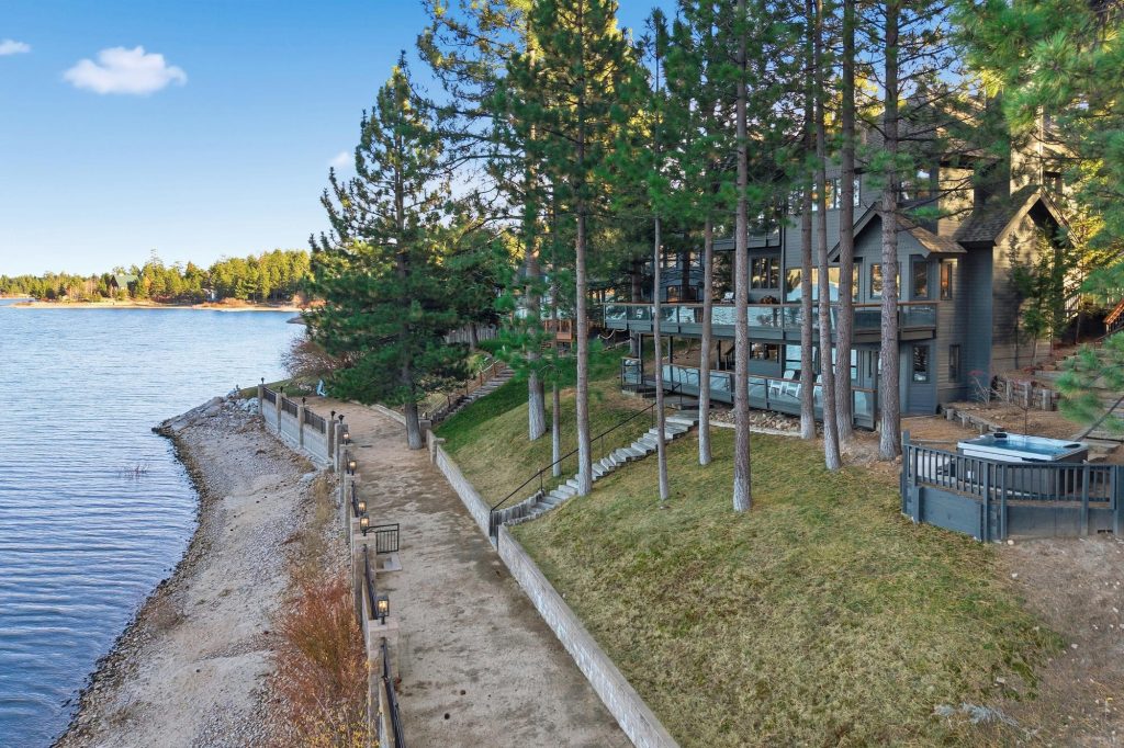 Lakefront property with direct access to the lake, surrounded by trees and scenic shoreline