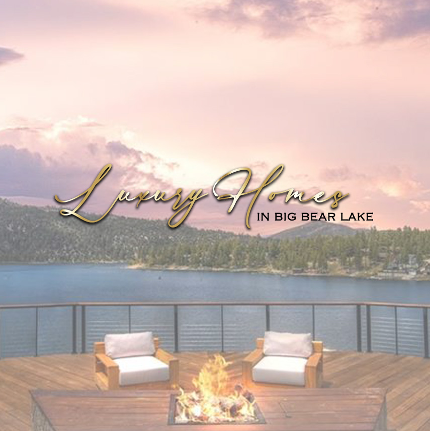 A wide shot of Big Bear Lake and the surrounding mountains, with a deck and fire pit in the foreground. The text "Luxury Homes IN BIG BEAR LAKE" is overlaid in a cursive, golden font.