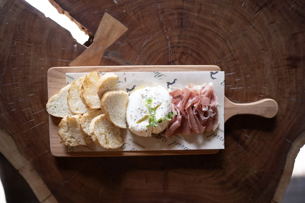 Charcuterie board with crostini, burrata, and prosciutto at Barrel 33.