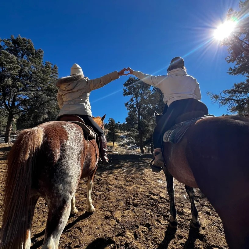 Riders enjoying a scenic horseback trail adventure through the forest at Starlight Mountain Theatre Ranch.