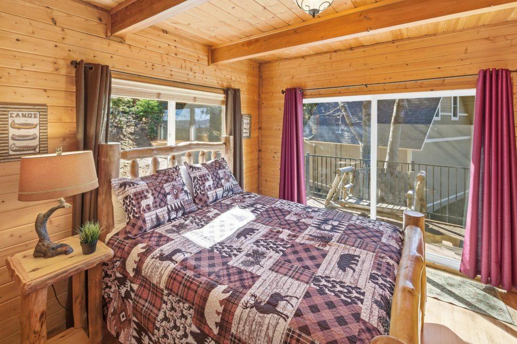 Nature's Dream bedroom with rustic decor and balcony access