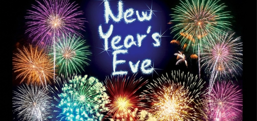 New Years Eve in glowing lights with fireworks against black background