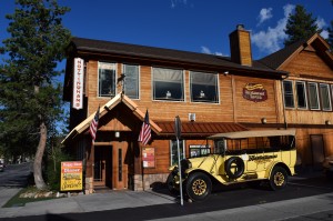The exterior of a restaurant called Nottingham's is shown in Big Bear, featuring a classic yellow vehicle parked out front.