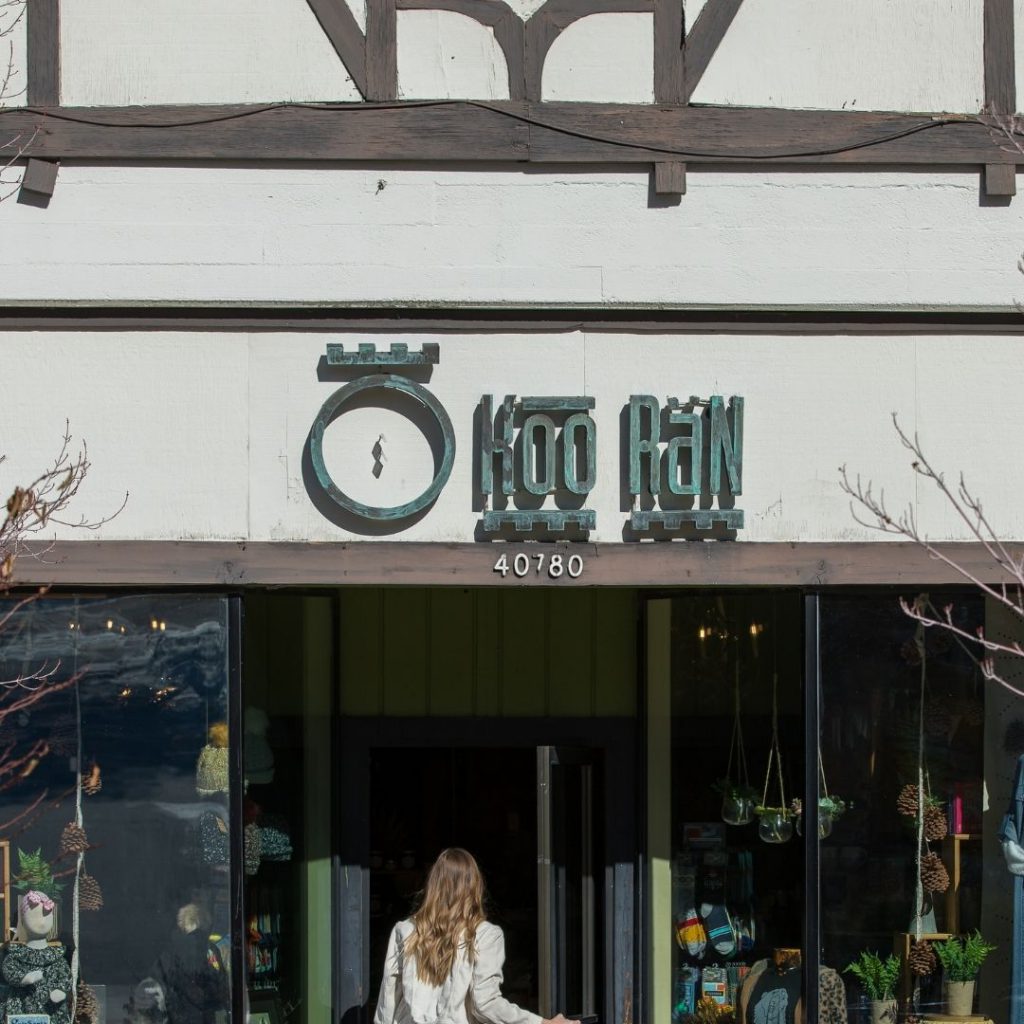 A woman walking toward the entrance of the "KooRan" boutique in Big Bear.