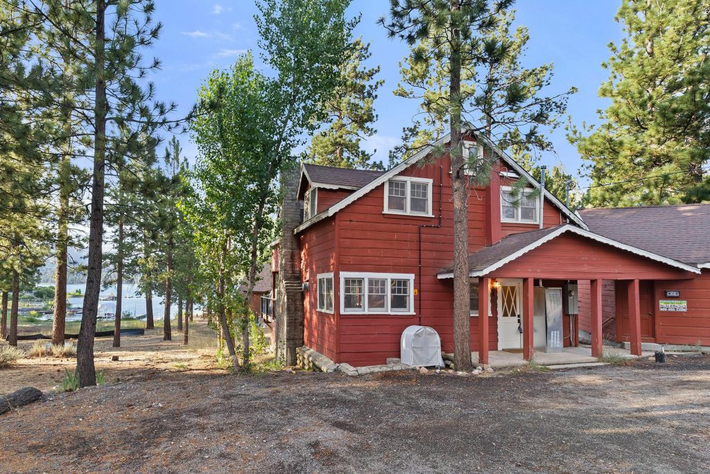 Red cabin near Big Bear Lake surrounded by pine trees and mountain scenery