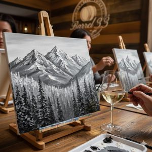 Guests painting black and white mountain landscape on canvas while enjoying wine at Barrel 33 Paint and Sip event in Big Bear