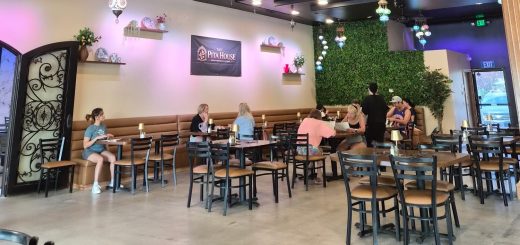 Guests dining inside The Pita House featuring elegant Turkish-style hanging lights and cozy seating.