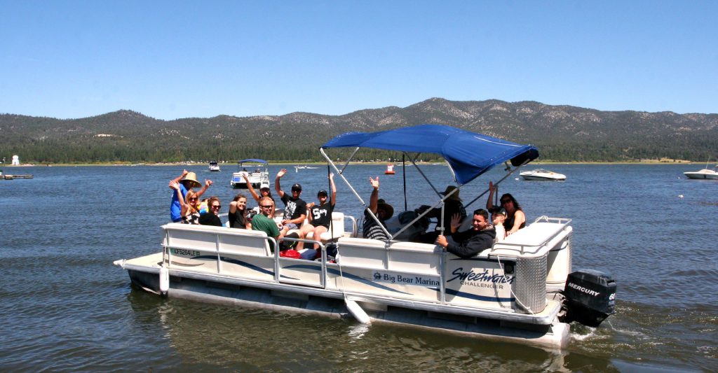 Visitors enjoying a pontoon boat rental on Big Bear Lake from Big Bear Marina