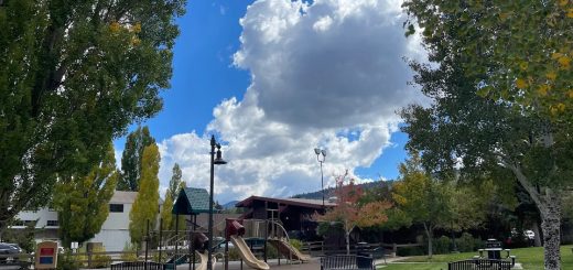 Playground and green space at Rotary Pine Knot Park with benches and trees, Big Bear Lake