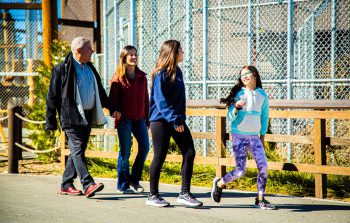 Family walking along Big Bear Alpine Zoo pathway during Run Wild Through Moonridge event